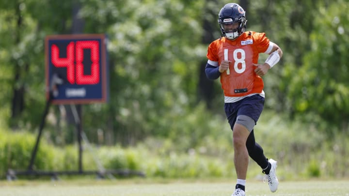 Rookie QB Caleb Williams jogs to his next throwing station during warmups at Bears minicamp. Rookie QB Caleb Williams jogs to his next throwing station during warmups at Bears minicamp.