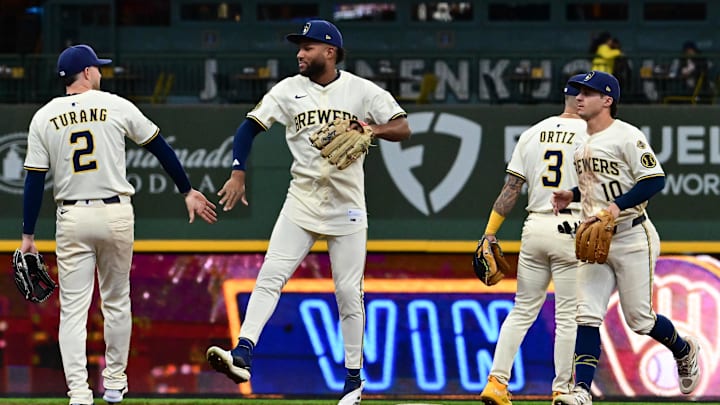 Apr 16, 2025; Milwaukee, Wisconsin, USA;  Milwaukee Brewers second baseman Brice Turang (2),  left fielder Jackson Chourio (11) and right fielder Sal Frelick (10) celebrate after defeating the Detroit Tigers at American Family Field. Mandatory Credit: Benny Sieu-Imagn Images