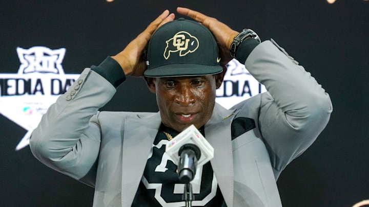 Jul 9, 2025; Frisco, TX, USA; Colorado head coach Deion Sanders fixes his cap prior to speaking with the media during 2025 Big 12 Football Media Days at The Star. Mandatory Credit: Raymond Carlin III-Imagn Images