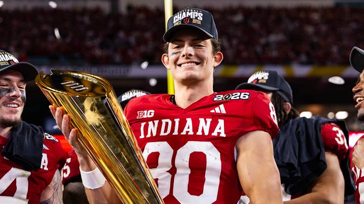 Jan 19, 2026; Miami Gardens, FL, USA; Indiana Hoosiers wide receiver Charlie Becker (80) celebrates with the trophy after defeating the Miami Hurricanes in the College Football Playoff National Championship game at Hard Rock Stadium. Mandatory Credit: Mark J. Rebilas-Imagn Images