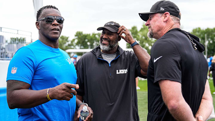 Former Lions player Robert Porcher, left, talks to general manager Brad Holmes, center, and head coach Dan Campbell after practice at training camp at Meijer Performance Center in Allen Park on Thursday, August 21, 2025.