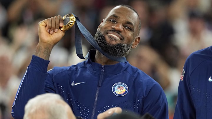 United States guard LeBron James (6) celebrates with the gold medal after the game against France in the men's basketball gold medal game during the Paris 2024 Olympic Summer Games at Accor Arena. United States guard LeBron James (6) celebrates with the gold medal after the game against France in the men's basketball gold medal game during the Paris 2024 Olympic Summer Games at Accor Arena.