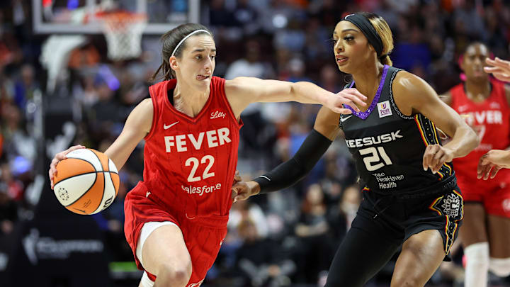 Sep 25, 2024; Uncasville, Connecticut, USA; Indiana Fever guard Caitlin Clark (22) drives to the basket defended by Connecticut Sun guard DiJonai Carrington (21) during the first half during game two of the first round of the 2024 WNBA Playoffs at Mohegan Sun Arena. Mandatory Credit: Paul Rutherford-Imagn Images