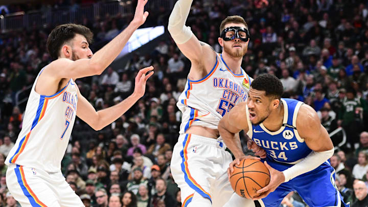 Mar 16, 2025; Milwaukee, Wisconsin, USA;  Milwaukee Bucks forward Giannis Antetokounmpo (34) looks for a shot against Oklahoma City Thunder center Chet Holmgren (7) and center Isaiah Hartenstein (55) in the third quarter at Fiserv Forum. Mandatory Credit: Benny Sieu-Imagn Images