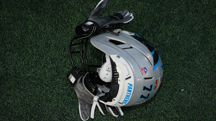 Carolina Panthers tackle Yosh Nijman's (77) helmet on the field after a game
