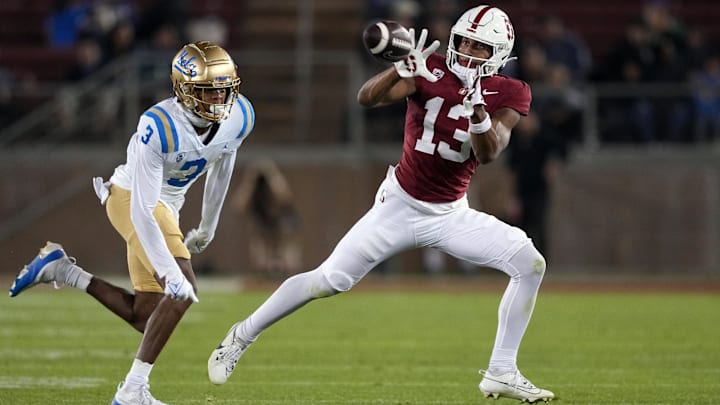 Oct 21, 2023; Stanford, California, USA; Stanford Cardinal wide receiver Elic Ayomanor (13) catches a pass against UCLA Bruins defensive back Devin Kirkwood (3) during the fourth quarter at Stanford Stadium. Mandatory Credit: Darren Yamashita-Imagn Images