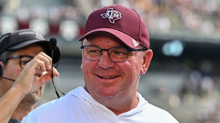 Oct 5, 2024; College Station, Texas, USA; Texas A&M Aggies head coach Mike Elko gets ready for a pre-game interview with the SEC Nation prior to the game against the Missouri Tigers at Kyle Field. Mandatory Credit: Maria Lysaker-Imagn Images. 