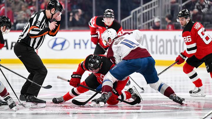 Oct 20, 2026; Newark, New Jersey, USA;  New Jersey Devils center Nico Hischier (13) and Colorado Avalanche center Brock Nelson (11) face off during the second period at Prudential Center.  Mandatory Credit: John Jones-Imagn Images