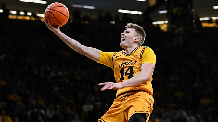Feb 25, 2026; Iowa City, Iowa, USA; Iowa Hawkeyes guard Bennett Stirtz (14) goes to the basket against the Ohio State Buckeyes during the second half at Carver-Hawkeye Arena. Mandatory Credit: Jeffrey Becker-Imagn Images