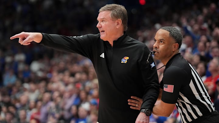 Jan 25, 2025; Lawrence, Kansas, USA; An official restrains Kansas Jayhawks head coach Bill Self against the Houston Cougars during overtime at Allen Fieldhouse. Mandatory Credit: Denny Medley-Imagn Images