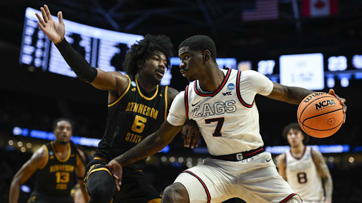 Mar 19, 2026; Portland, OR, USA; Gonzaga Bulldogs guard Tyon Grant-Foster (7) drives against Kennesaw State Owls forward Frankquon Sherman (6) during the first half of a first round game of the men's 2026 NCAA Tournament at Moda Center. Mar 19, 2026; Portland, OR, USA; Gonzaga Bulldogs guard Tyon Grant-Foster (7) drives against Kennesaw State Owls forward Frankquon Sherman (6) during the first half of a first round game of the men's 2026 NCAA Tournament at Moda Center.