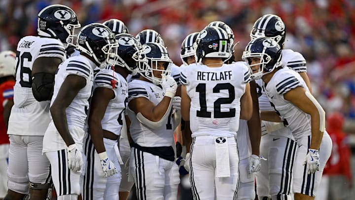 Sep 6, 2024; Dallas, Texas, USA; Brigham Young Cougars quarterback Jake Retzlaff (12) huddles with his team during the game between the Southern Methodist Mustangs and the Brigham Young Cougars at Gerald J. Ford Stadium.