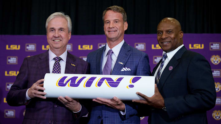 Dec 1, 2025; Baton Rouge, LA, USA; LSU president Wade Rousse, left, LSU new head coach Lane Kiffin and LSU athletic director Verge Ausberry stand together at South Stadium Club at Tiger Stadium. Mandatory Credit: Matthew Hinton-Imagn Images Dec 1, 2025; Baton Rouge, LA, USA; LSU president Wade Rousse, left, LSU new head coach Lane Kiffin and LSU athletic director Verge Ausberry stand together at South Stadium Club at Tiger Stadium. Mandatory Credit: Matthew Hinton-Imagn Images