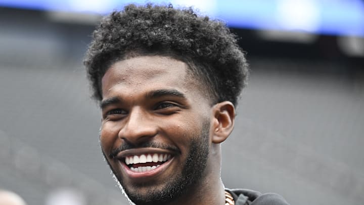 Sanders cracks a smile.