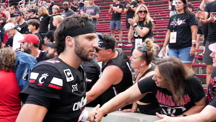 Cincinnati Bearcats quarterback Brendan Sorsby (2) high-fives fans after defeating the Northwestern State Demons 70-0, Saturday, Sept. 13, 2025, at Nippert Stadium in Cincinnati.
