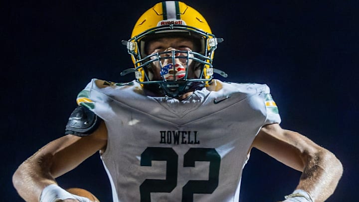 Howell's Bryce Kish flexes after his first touchdown of the evening during a victory over Brighton Friday, Oct. 17, 2025.