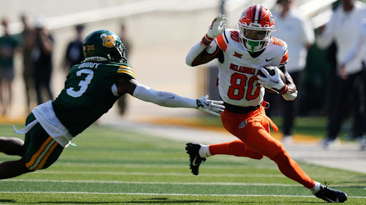 Oct 26, 2024; Waco, Texas, USA;  Oklahoma State Cowboys wide receiver Brennan Presley (80) runs the ball after a catch against Baylor Bears safety Devyn Bobby (3) during the first half at McLane Stadium. Mandatory Credit: Chris Jones-Imagn Images