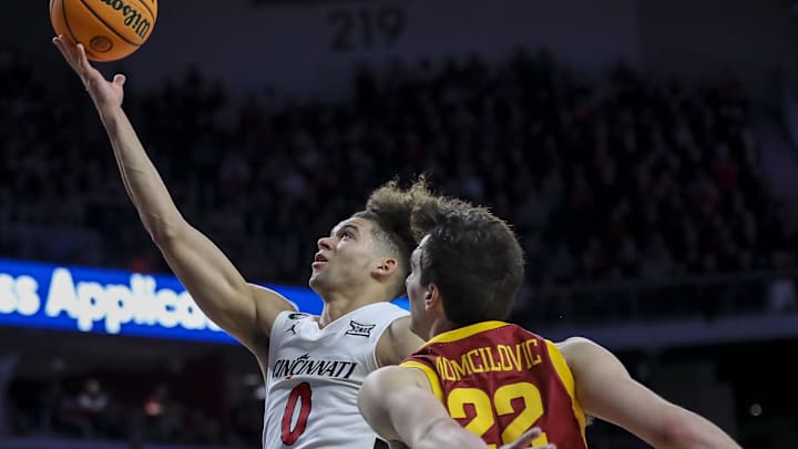 Feb 13, 2024; Cincinnati, Ohio, USA; Cincinnati Bearcats guard Dan Skillings Jr. (0) shoots against Iowa State Cyclones forward Milan Momcilovic (22) in the second half at Fifth Third Arena. Mandatory Credit: Katie Stratman-Imagn Images Feb 13, 2024; Cincinnati, Ohio, USA; Cincinnati Bearcats guard Dan Skillings Jr. (0) shoots against Iowa State Cyclones forward Milan Momcilovic (22) in the second half at Fifth Third Arena. Mandatory Credit: Katie Stratman-Imagn Images