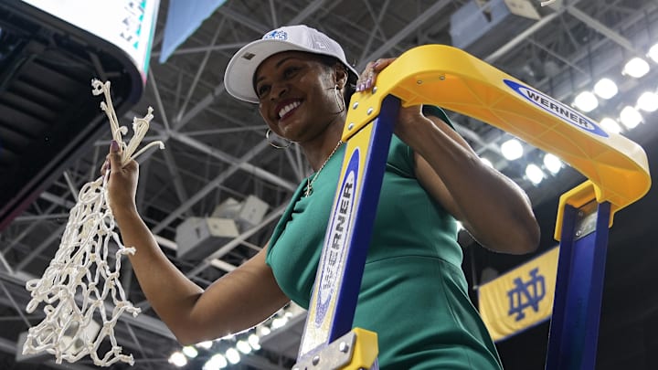 Mar 10, 2024; Greensboro, NC, USA; Notre Dame Fighting Irish head coach Niele Ivey displays the tournament net after defeating the NC State Wolfpack at Greensboro Coliseum. \