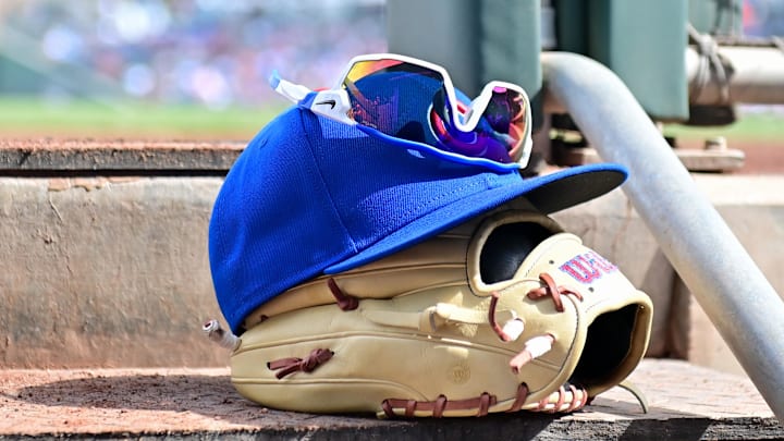 Feb 27, 2024; Mesa, Arizona, USA; General view of a Chicago Cubs glove, hat and glasses in the first inning against the Cincinnati Reds during a spring training game at Sloan Park. Feb 27, 2024; Mesa, Arizona, USA; General view of a Chicago Cubs glove, hat and glasses in the first inning against the Cincinnati Reds during a spring training game at Sloan Park.