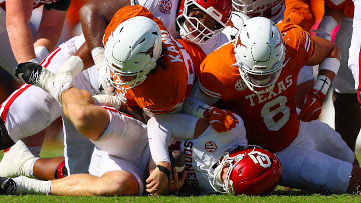 Oklahoma quarterback John Mateer gets dragged down by the Texas defense in the Red River Rivalry.