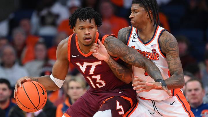 Jan 21, 2026; Syracuse, New York, USA; Virginia Tech Hokies forward Amani Hansberry (13) drives against Syracuse Orange forward Donnie Freeman (1) during the second half at the JMA Wireless Dome. Mandatory Credit: Rich Barnes-Imagn Images Jan 21, 2026; Syracuse, New York, USA; Virginia Tech Hokies forward Amani Hansberry (13) drives against Syracuse Orange forward Donnie Freeman (1) during the second half at the JMA Wireless Dome. Mandatory Credit: Rich Barnes-Imagn Images