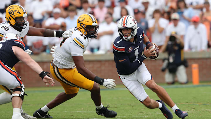 Sep 7, 2024; Auburn, Alabama, USA;  Auburn Tigers quarterback Payton Thorne (1) scrambles from California Golden Bears defenders during the third quarter at Jordan-Hare Stadium. Mandatory Credit: John Reed-Imagn Images