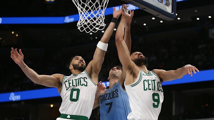 Mar 31, 2025; Memphis, Tennessee, USA: Boston Celtics forward Jayson Tatum (0) and guard Derrick White (9) reach for a rebound with Memphis Grizzlies forward Santi Aldama (7) during the fourth quarter at FedExForum. Mandatory Credit: Petre Thomas-Imagn Images Mar 31, 2025; Memphis, Tennessee, USA: Boston Celtics forward Jayson Tatum (0) and guard Derrick White (9) reach for a rebound with Memphis Grizzlies forward Santi Aldama (7) during the fourth quarter at FedExForum. Mandatory Credit: Petre Thomas-Imagn Images