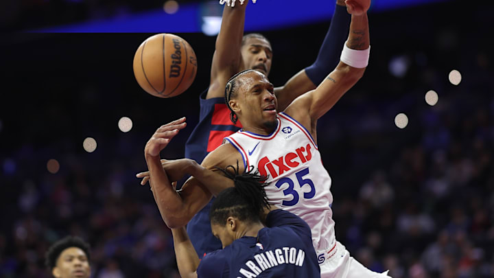 Mar 26, 2025; Philadelphia, Pennsylvania, USA; Philadelphia 76ers forward Marcus Bagley (35) is fouled while driving against Washington Wizards guard Bub Carrington (8) during the third quarter at Wells Fargo Center. Mandatory Credit: Bill Streicher-Imagn Images