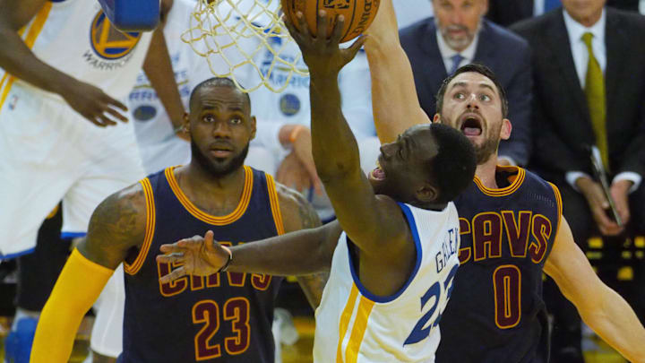 Jun 1, 2017; Oakland, CA, USA; Golden State Warriors forward Draymond Green (23) shoots against Cleveland Cavaliers forward LeBron James (23) and forward Kevin Love (0) in the first half of the NBA Finals at Oracle Arena. Mandatory Credit: Kelley L Cox-Imagn Images