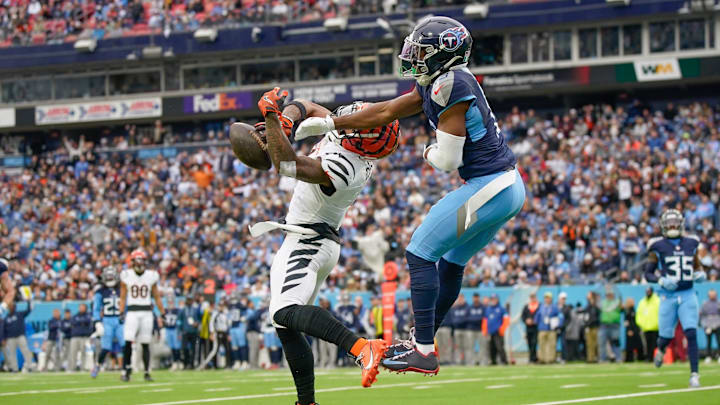 Tennessee Titans cornerback Chidobe Awuzie (13) breaks up a pass intended for Cincinnati Bengals wide receiver Ja'Marr Chase (1) during the second quarter at Nissan Stadium in Nashville, Tenn., Sunday, Dec. 15, 2024.