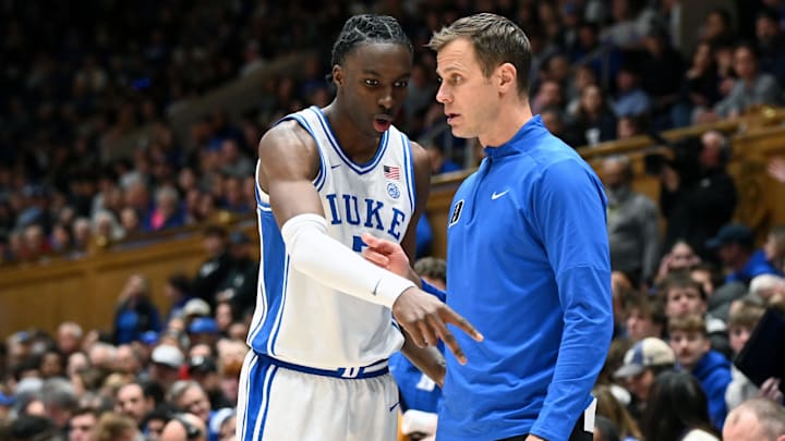 Jan 24, 2026; Durham, North Carolina, USA; Duke Blue Devils forward Dame Sarr (7) consults with head coach Jon Scheyer (right) during the first half against the Wake Forest Demon Deacons.