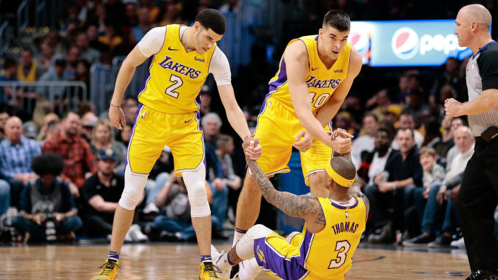 Mar 9, 2018; Denver, CO, USA; Los Angeles Lakers guard Lonzo Ball (2) and center Ivica Zubac (40) help guard Isaiah Thomas (3) up in the first quarter against the Denver Nuggets at the Pepsi Center. Mandatory Credit: Isaiah J. Downing-USA TODAY Sports