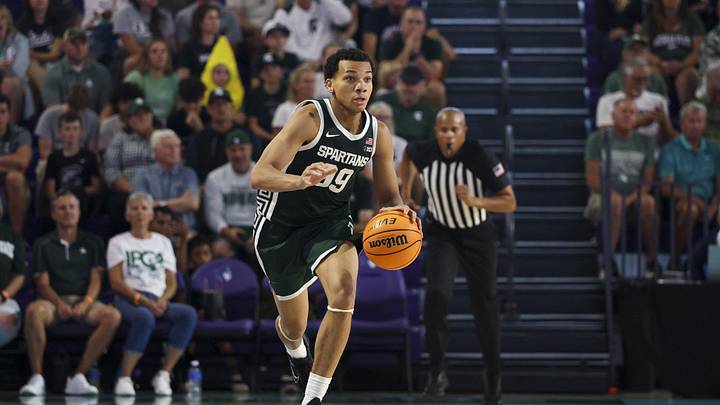 Nov 25, 2025; Fort Myers, Florida, USA; Michigan State Spartans guard Divine Ugochukwu (99) controls the ball against the East Carolina Pirates in the second half at Suncoast Credit Union Arena. Mandatory Credit: Nathan Ray Seebeck-Imagn Images Nov 25, 2025; Fort Myers, Florida, USA; Michigan State Spartans guard Divine Ugochukwu (99) controls the ball against the East Carolina Pirates in the second half at Suncoast Credit Union Arena. Mandatory Credit: Nathan Ray Seebeck-Imagn Images