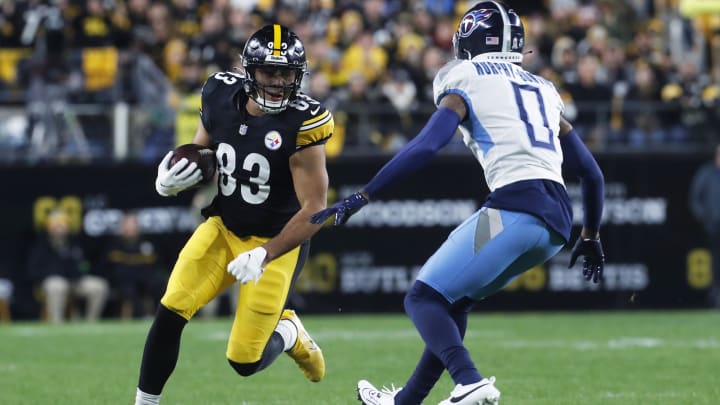 Nov 2, 2023; Pittsburgh, Pennsylvania, USA;  Pittsburgh Steelers tight end Connor Heyward (83) runs after a catch as Tennessee Titans cornerback Sean Murphy-Bunting (0) defends during the first quarter at Acrisure Stadium. Mandatory Credit: Charles LeClaire-USA TODAY Sports