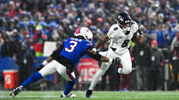 Baltimore Ravens quarterback Lamar Jackson (8) runs the ball against Buffalo Bills safety Damar Hamlin (3) during the second quarter.