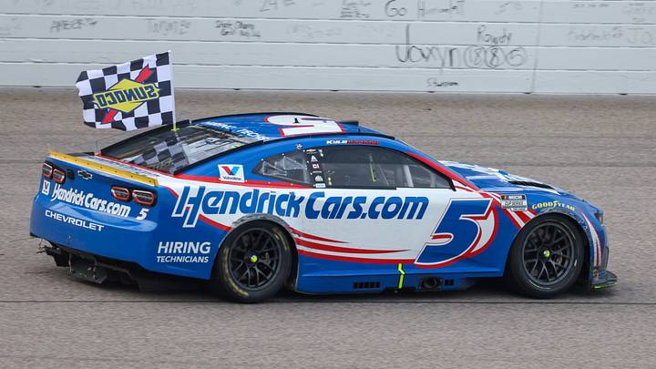 Sep 27, 2026; Kansas City, Kansas, USA; NASCAR Cup Series driver Kyle Larson (5) circles the track with the checkered flag after winning the Hollywood Casino 400 at Kansas Speedway. Scott Sewell-Imagn Images Sep 27, 2026; Kansas City, Kansas, USA; NASCAR Cup Series driver Kyle Larson (5) circles the track with the checkered flag after winning the Hollywood Casino 400 at Kansas Speedway. Scott Sewell-Imagn Images
