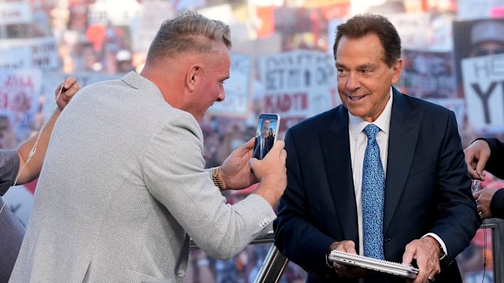 Oct. 4, 2025; Tuscaloosa, Alabama, USA; Pat McAfee takes a cell phone video of former Alabama head coach Nick Saban, now a co-host of the ESPN College GameDay show, as he comes on set on location on the Quad at the University of Alabama before the Alabama versus Vanderbilt game.