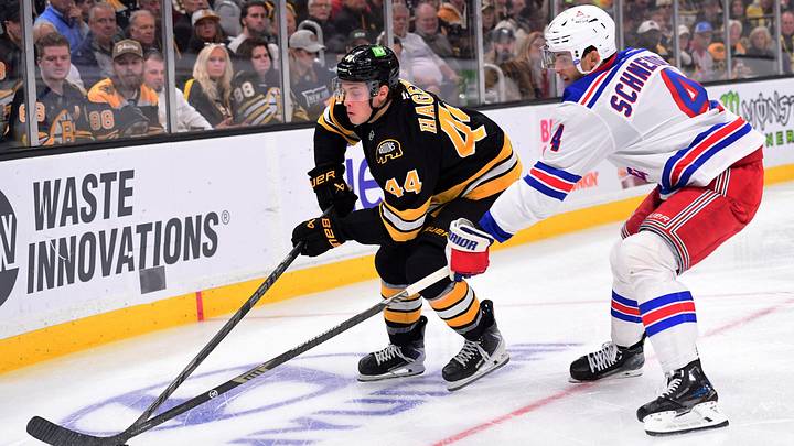 Sep 29, 2026; Boston, Massachusetts, USA;  Boston Bruins center James Hagens (44) and New York Rangers defenseman Braden Schneider (4) battle for the puck during the first period at TD Garden.  Mandatory Credit: Bob DeChiara-Imagn Images