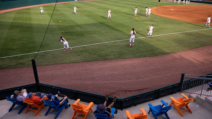 Fans sit in the left field while watching the Gators warm up. The Florida women   s softball team