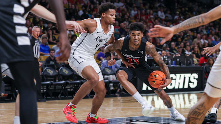 Feb 5, 2025; Orlando, Florida, USA; Cincinnati Bearcats forward Dillon Mitchell (23) drives to the basket against UCF Knights guard Keyshawn Hall (4) during the first half at Addition Financial Arena. Mandatory Credit: Mike Watters-Imagn Images Feb 5, 2025; Orlando, Florida, USA; Cincinnati Bearcats forward Dillon Mitchell (23) drives to the basket against UCF Knights guard Keyshawn Hall (4) during the first half at Addition Financial Arena. Mandatory Credit: Mike Watters-Imagn Images