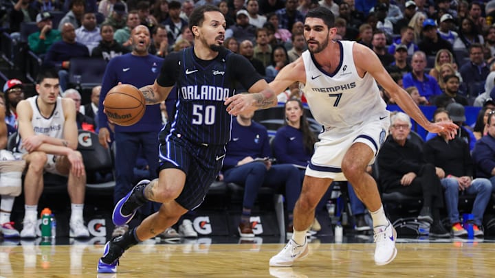 Orlando Magic guard Cole Anthony (50) drives around Memphis Grizzlies forward Santi Aldama (7) during the second quarter at Kia Center. Orlando Magic guard Cole Anthony (50) drives around Memphis Grizzlies forward Santi Aldama (7) during the second quarter at Kia Center.