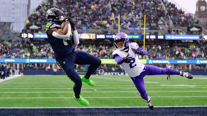 Dec 22, 2024; Seattle, Washington, USA; Seattle Seahawks wide receiver DK Metcalf (14) catches a pass for a touchdown over Minnesota Vikings cornerback Stephon Gilmore (2) during the first half at Lumen Field.