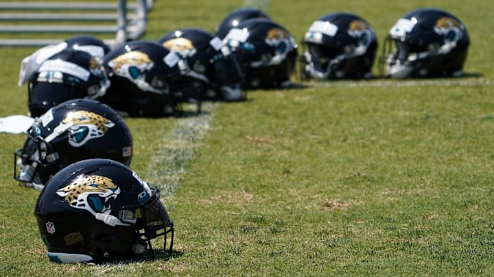May 27, 2021; Jacksonville, Florida, USA; Jacksonville Jaguars players helmets sit pin the field during OTA at the Dream Finders Homes Practice Complex. Mandatory Credit: Jasen Vinlove-Imagn Images