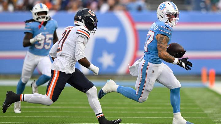 Tennessee Titans wide receiver Xavier Restrepo tries to elude Bears safety Cam Lewis in the first half Saturday night.
