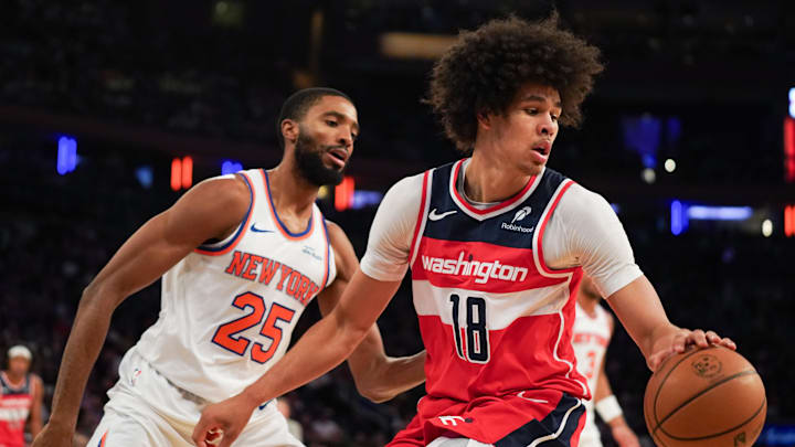 Nov 3, 2025; New York, New York, USA; Washington forward Kyshawn George (18) is defended by New York Knicks guard Mikal Bridges (25) during the second half at Madison Square Garden. Mandatory Credit: Lucas Boland-Imagn Images