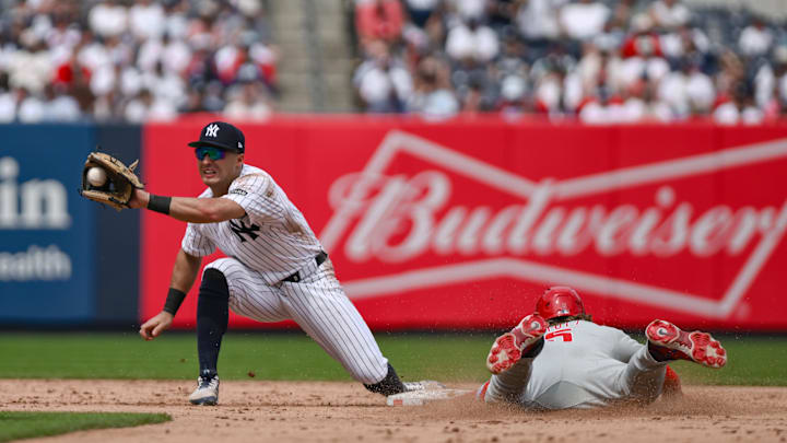 Jul 26, 2025; Bronx, New York, USA; Philadelphia Phillies second baseman Bryson Stott (5) steals second base ahead of the tag by New York Yankees shortstop Anthony Volpe (11) during the sixth inning at Yankee Stadium. Mandatory Credit: John Jones-Imagn Images