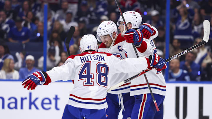 Apr 19, 2026; Tampa, Florida, USA; Montreal Canadiens forward Juraj Slafkovsky (20) reacts to scoring a goal with defenseman Lane Hutson (48) and forward Nick Suzuki (14) against the Tampa Bay Lightning during the second period in game one of the first round of the 2026 Stanley Cup Playoffs at Benchmark International Arena. Mandatory Credit: Morgan Tencza-Imagn Images