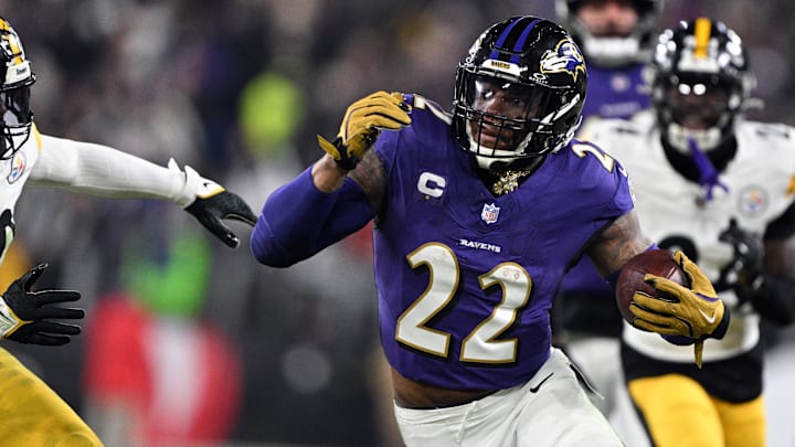 Jan 11, 2025; Baltimore, Maryland, USA; Baltimore Ravens running back Derrick Henry (22) runs against Pittsburgh Steelers linebacker Elandon Roberts (50) in the second quarter in an AFC wild card game at M&T Bank Stadium. Mandatory Credit: Tommy Gilligan-Imagn Images