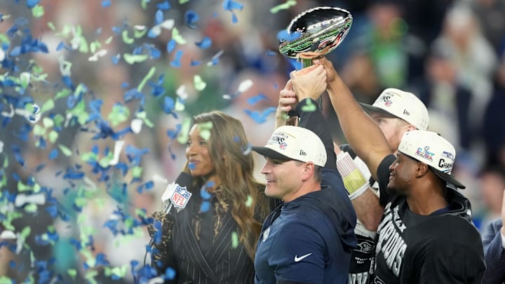 Feb 8, 2026; Santa Clara, CA, USA;  Seattle Seahawks head coach Mike MacDonald and Seattle Seahawks running back Kenneth Walker III (9) hoist the Vince Lombardi Trophy after defeating the New England Patriots in Super Bowl LX at Levi's Stadium. Mandatory Credit: Kirby Lee-Imagn Images